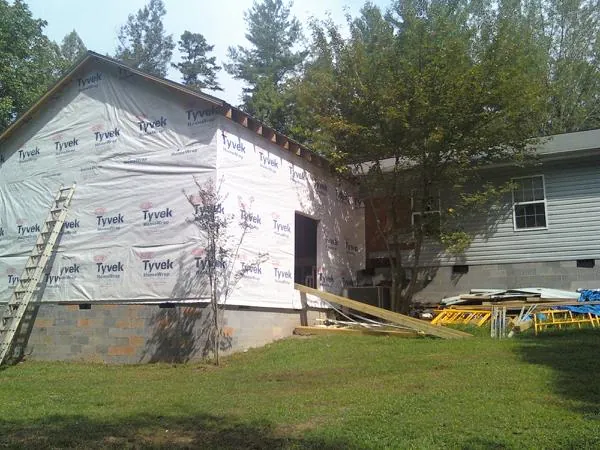 Tyvek wrapped gable on a new room addition beside an existing home in Rock Valley